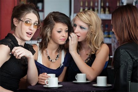 simsearch:400-05138908,k - Four girls sharing secrets in a small cafe Photographie de stock - Aubaine LD & Abonnement, Code: 400-04768653