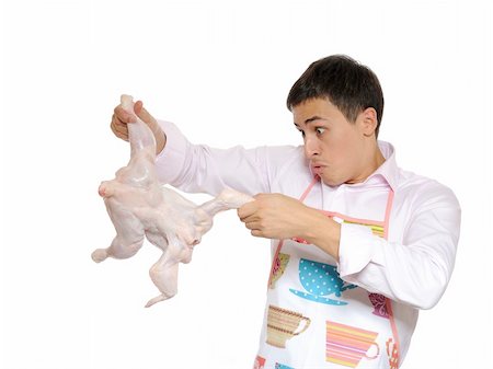 raw chicken dishes - Handsome young man holding chicken preparing to cook romantic dinner. isolated on white background Stock Photo - Budget Royalty-Free & Subscription, Code: 400-04768747