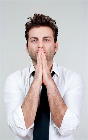 simsearch:400-04178541,k - businessman in white shirt and tie holding hands together, praying - isolated on gray Photographie de stock - Aubaine LD & Abonnement, Code: 400-04769181