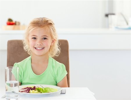 Portrait of a cute girl eating a healthy salad for lunch in the kitchen Stock Photo - Budget Royalty-Free & Subscription, Code: 400-04769414