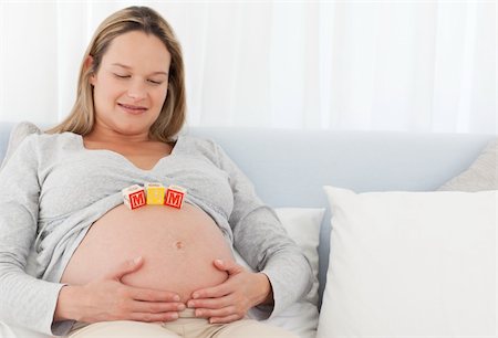 simsearch:400-04176771,k - Pretty pregnant woman with letters on her belly resting on a bed Stock Photo - Budget Royalty-Free & Subscription, Code: 400-04769442