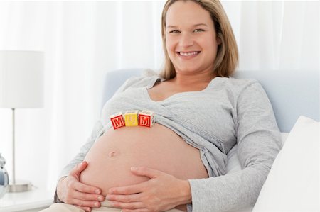 simsearch:400-04266869,k - Portrait of a future mom with baby letters on her belly and smiling at the camera Stock Photo - Budget Royalty-Free & Subscription, Code: 400-04769452