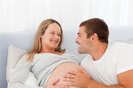 simsearch:400-04266840,k - Lovely future parents resting on a bed and looking at each other Photographie de stock - Aubaine LD & Abonnement, Code: 400-04769472