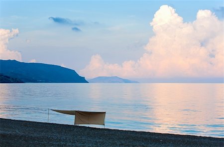 simsearch:400-09011314,k - Beautiful sunset in soft pink-blue colors, shining sea surface and sunshade on beach (Crimea, Ukraine). Stockbilder - Microstock & Abonnement, Bildnummer: 400-04760086