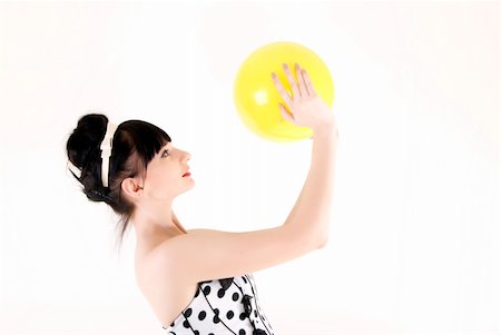 simsearch:400-04267059,k - Portrait of a young beautiful brunette posing with yellow ball Photographie de stock - Aubaine LD & Abonnement, Code: 400-04760487