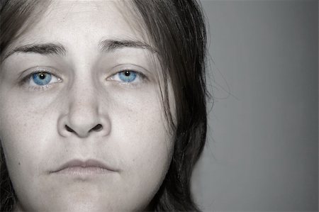 Dramatic faded portrait of a depressed, sad, young woman with stunning eyes. Almost black and white with real color eyes. Stock Photo - Budget Royalty-Free & Subscription, Code: 400-04760482