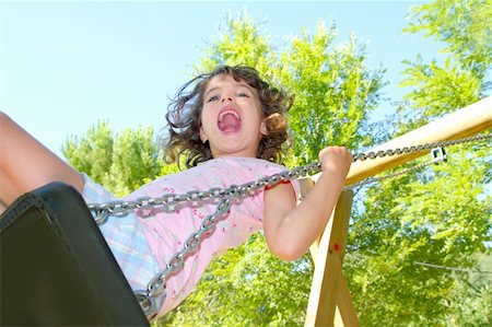 Girl swinging swing in outdoor park nature low angle view Stock Photo - Budget Royalty-Free & Subscription, Code: 400-04761834