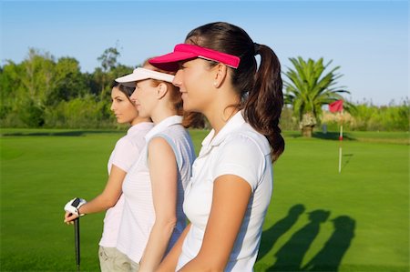 simsearch:400-04319321,k - Golf three woman in a row green grass course players Photographie de stock - Aubaine LD & Abonnement, Code: 400-04761830