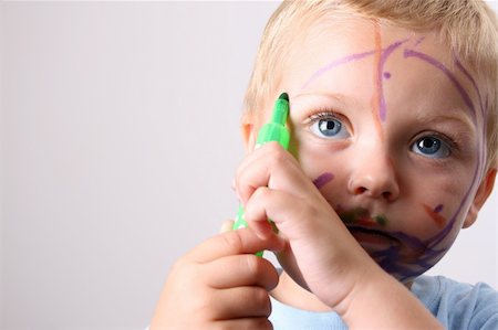 dirt in face with smile - Laughing Toddler playing with colored pens making a mess Stock Photo - Budget Royalty-Free & Subscription, Code: 400-04762834