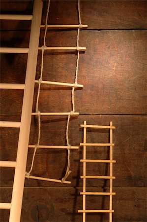 Three various ladders on old brown wooden background Foto de stock - Super Valor sin royalties y Suscripción, Código: 400-04763499