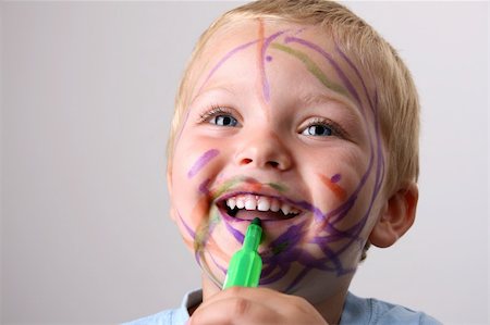 dirt in face with smile - Laughing Toddler playing with colored pens making a mess Stock Photo - Budget Royalty-Free & Subscription, Code: 400-04763712