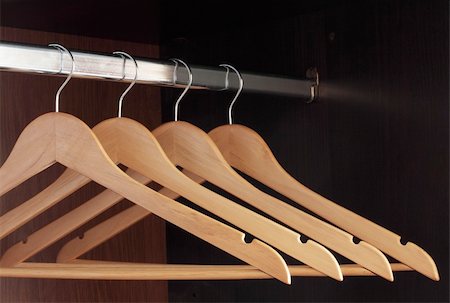 Wooden hangers hanging in an empty closet on the upper Stockbilder - Microstock & Abonnement, Bildnummer: 400-04774004