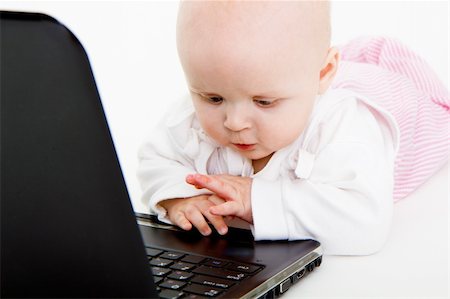 simsearch:400-04129482,k - Baby playing with laptop on white background Photographie de stock - Aubaine LD & Abonnement, Code: 400-04774576