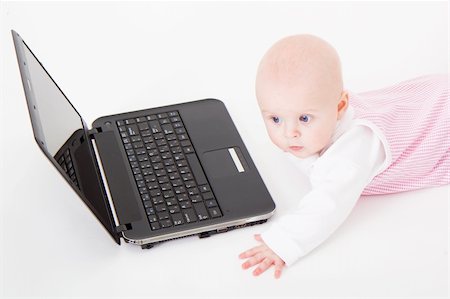 baby with laptop on a white background in studio Foto de stock - Super Valor sin royalties y Suscripción, Código: 400-04774577