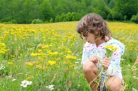 simsearch:400-05248187,k - Girl picking flowers in yellow spring meadow beautiful scenic in Pyrenees spain Photographie de stock - Aubaine LD & Abonnement, Code: 400-04774906