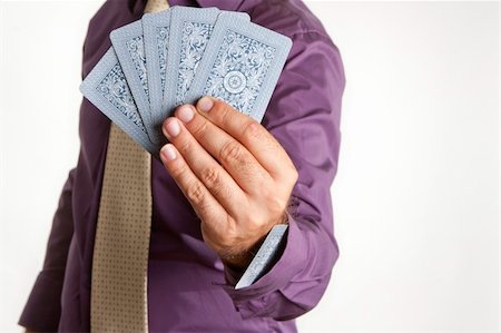 a man playing a poker game with an ace up his sleeve Stock Photo - Budget Royalty-Free & Subscription, Code: 400-04775631