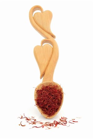 saffron strand - Saffron spice in a carved wooden love spoon with heart shapes and scattered over white background. Selective focus. Stock Photo - Budget Royalty-Free & Subscription, Code: 400-04776616