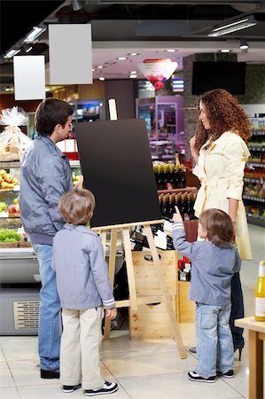 shopping mall advertising - Family with children in shop look at an empty board Stock Photo - Budget Royalty-Free & Subscription, Code: 400-04779172