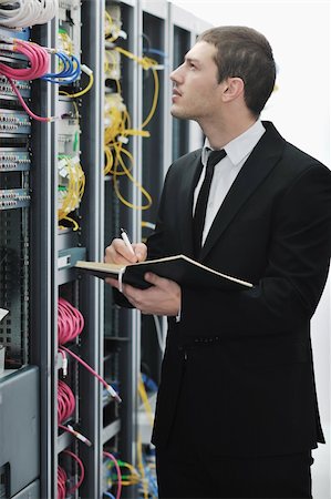 server room managers - young engeneer business man with notebook  in network server room Stock Photo - Budget Royalty-Free & Subscription, Code: 400-04779219