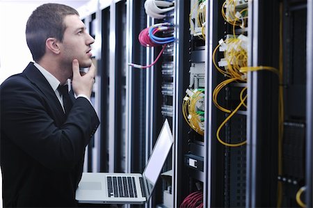 server room managers - young engeneer business man with thin modern aluminium laptop in network server room Stock Photo - Budget Royalty-Free & Subscription, Code: 400-04779224