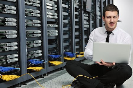 data backup - young engeneer business man with thin modern aluminium laptop in network server room Stock Photo - Budget Royalty-Free & Subscription, Code: 400-04779228