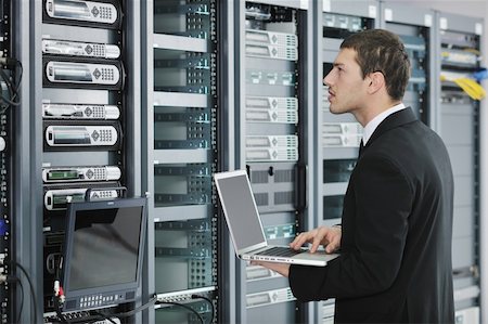 server room managers - young engeneer business man with thin modern aluminium laptop in network server room Stock Photo - Budget Royalty-Free & Subscription, Code: 400-04779222