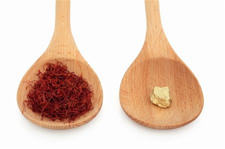 Saffron spice and gold nugget in wooden spoons over white background. Gram for gram equal value. Stock Photo - Budget Royalty-Free & Subscription, Code: 400-04779505