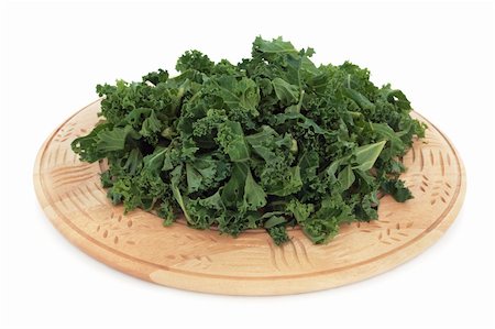 Chopped kale green cabbage on a rustic wooden chopping board, over white background. Stock Photo - Budget Royalty-Free & Subscription, Code: 400-04779508