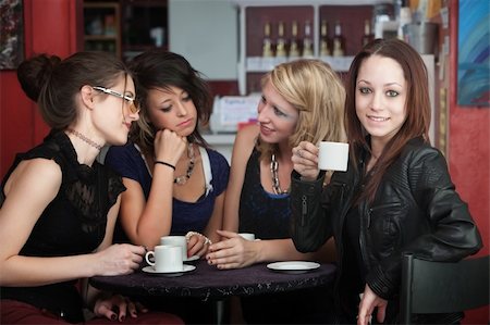 simsearch:400-04238163,k - A confident young woman drinks coffee with friends in a cafe Stock Photo - Budget Royalty-Free & Subscription, Code: 400-04779892