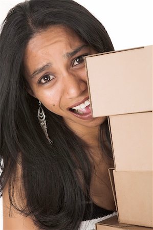 Young adult African-Indian businesswoman in casual office outfit carrying brown cardboard boxes on a white background. Not Isolated Stock Photo - Budget Royalty-Free & Subscription, Code: 400-04770224