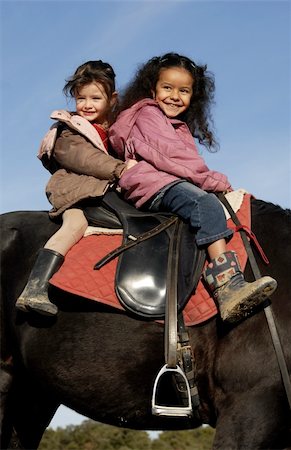 simsearch:400-04660370,k - two laughing little girls on a black horse Photographie de stock - Aubaine LD & Abonnement, Code: 400-04770343