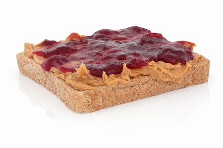 Peanut butter and raspberry jam on brown wholemeal bread, over white background. Stock Photo - Budget Royalty-Free & Subscription, Code: 400-04770740