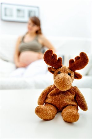 simsearch:400-05911635,k - Toy lying on table and pregnant female sitting on sofa at home  in background Foto de stock - Super Valor sin royalties y Suscripción, Código: 400-04771549