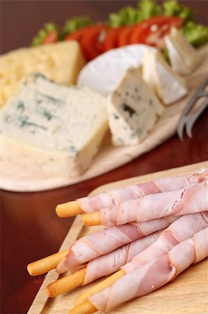 emmentaler cheese - Bacon wrapped grissini breadsticks and cheese board in background Stock Photo - Budget Royalty-Free & Subscription, Code: 400-04772173