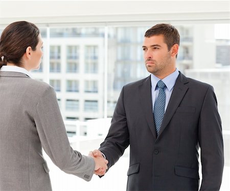 simsearch:400-04769433,k - Two charismatic businesspeople shaking their hands after a meeting Foto de stock - Royalty-Free Super Valor e Assinatura, Número: 400-04772244