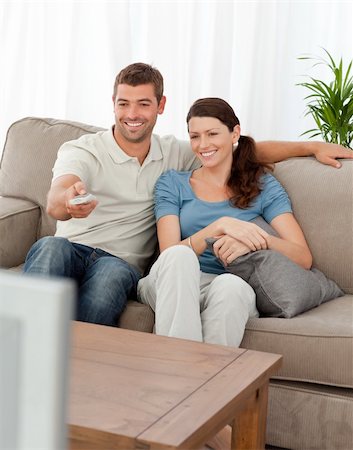 simsearch:400-04268918,k - Happy man changing channel while watching television with his wife at home Stockbilder - Microstock & Abonnement, Bildnummer: 400-04772285