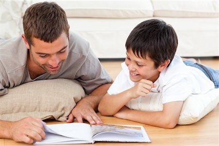 simsearch:400-04193532,k - Happy father and son reading a book together on the floor Stock Photo - Budget Royalty-Free & Subscription, Code: 400-04772280