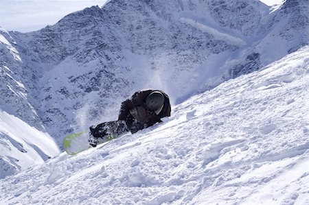 fallen on skis in snow - Snowboarder on the ski slope. Mount Cheget. Caucasus Mountains. Elbrus region. Stock Photo - Budget Royalty-Free & Subscription, Code: 400-04772305