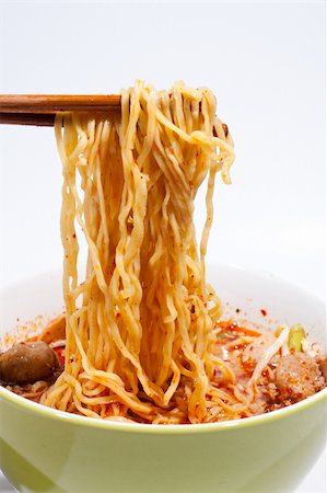 simsearch:400-05269297,k - Using chopsticks creep up from the bowl of noodles. Photographie de stock - Aubaine LD & Abonnement, Code: 400-04773005