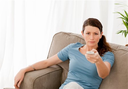 simsearch:400-04268918,k - Charismatic woman watching television at home and changing channel Stockbilder - Microstock & Abonnement, Bildnummer: 400-04773001
