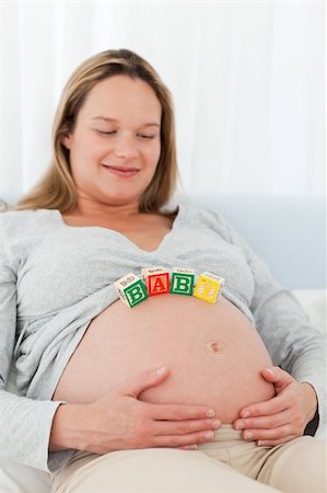 simsearch:400-04266869,k - Portrait of a future mom with baby letters on her belly and smiling at the camera Stock Photo - Budget Royalty-Free & Subscription, Code: 400-04773037