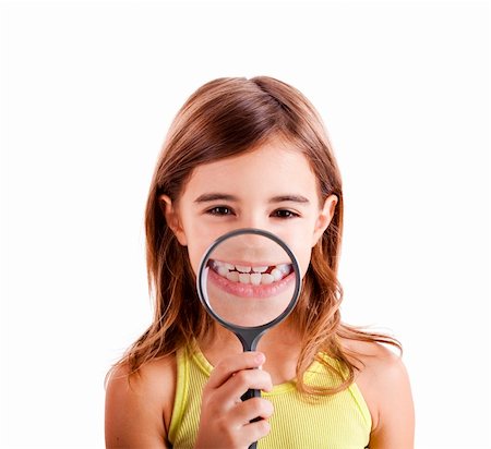 Beautiful girl showing teethes through a magnifying glass Stock Photo - Budget Royalty-Free & Subscription, Code: 400-04773561