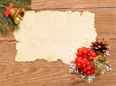 scrolled up paper - christmas decoration and old paper on brown wood texture Stock Photo - Budget Royalty-Free & Subscription, Code: 400-04773789