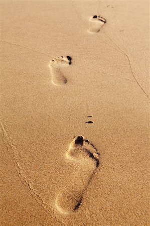 Three human footprints on the beach sand leading away from the viewer Stock Photo - Budget Royalty-Free & Subscription, Code: 400-04785555