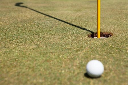 Golf ball and flag in hole on green Stock Photo - Budget Royalty-Free & Subscription, Code: 400-04785551