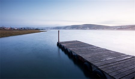 Sunrise over river and pier with mist in the distance Stock Photo - Budget Royalty-Free & Subscription, Code: 400-04785552