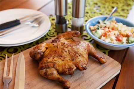 Whole cooked chicken on cutting board served with salad Stock Photo - Budget Royalty-Free & Subscription, Code: 400-04785553