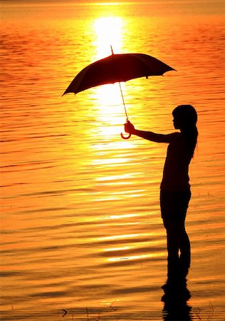 silhouette girl with umbrella - silhouette of young woman against summer sunset Stock Photo - Budget Royalty-Free & Subscription, Code: 400-04785650