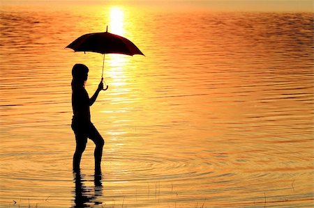 silhouette girl with umbrella - silhouette of young woman against summer sunset Stock Photo - Budget Royalty-Free & Subscription, Code: 400-04785651