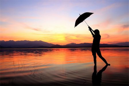 silhouette girl with umbrella - silhouette of young woman against summer sunset Stock Photo - Budget Royalty-Free & Subscription, Code: 400-04785653